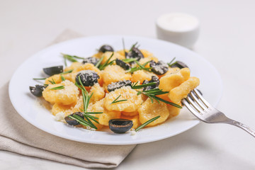 Italian Gnocchi with cream sauce, olives and rosemary