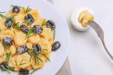 Italian Gnocchi with cream sauce, olives and rosemary