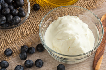 Cottage cheese in a bowl with blueberries in the background