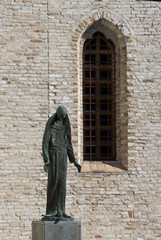 Fototapeta na wymiar The statue representing St. Francis adjacent to the former convent.Pordenone. italy