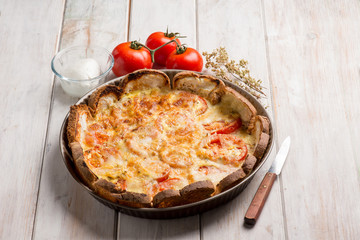 pizza with sliced bread fresh tomatoes and mozzarella
