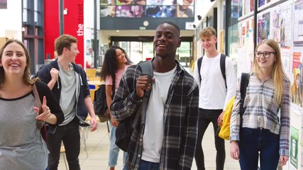 Portrait Of Student Group In Communal Area Of Busy College