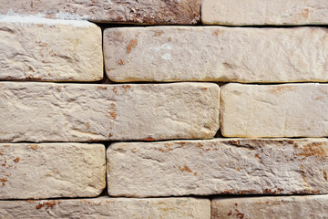 beige brick wall close-up - background or texture