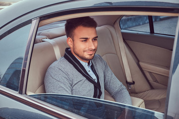 A handsome businessman in luxury car