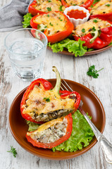 Oven baked sweet paprikas stuffed with mushrooms in cream sauce and cheese