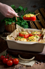 Oven baked sweet paprikas stuffed with mushrooms in cream sauce and cheese