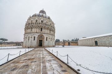 Baptistery of Pisa after a winter snowfall. Square of Miracles at dawn