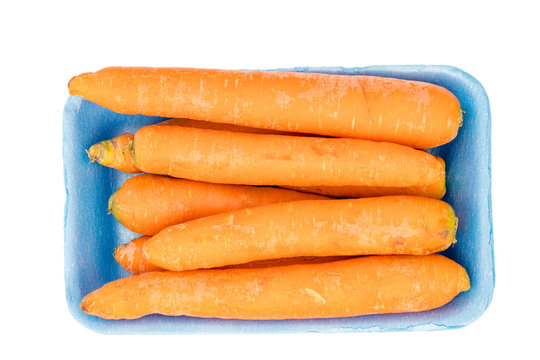 Carrots in blue retail package, top view, isolated on white background with clipping path.