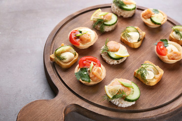 Tasty appetizers with codfish caviar on wooden board