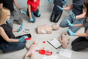 Stay away moment during the defibrillation process on a first aid group training indoors - obrazy, fototapety, plakaty