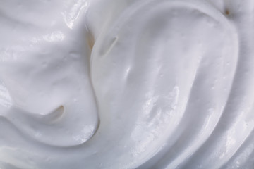 close up of a white whipped or sour cream on white background