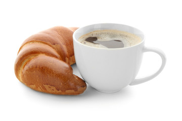 Delicious croissant and cup of coffee on white background