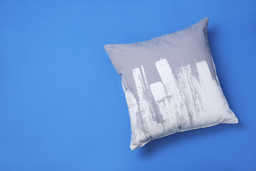 Stylish soft pillow on color background