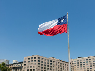 Chileans walking near the giant flag on Avenida La Alameda with the citizenship Square, in downtown Santiago de Chile. Chile.