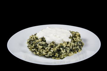 Spinach with rice and yoghurt isolated in black