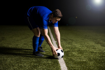 Soccer player about to kick the football