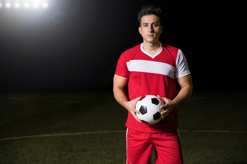 Footballer on field with ball
