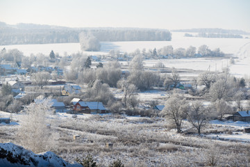 Fototapeta na wymiar Rural winter landscape with white frost in the ravine