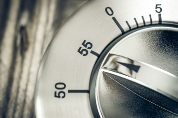 55 Minutes - Macro Of An Analog Chrome Kitchen Timer On Wooden Table