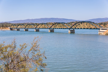 Fototapeta na wymiar Railway bridge over water in portuguese landscape