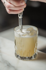 Glass of coffee with cream and ice on wooden table