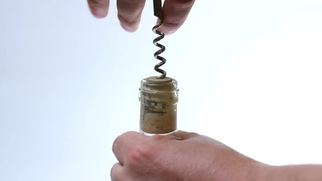 Hand loosen wine bottle with corkscrew