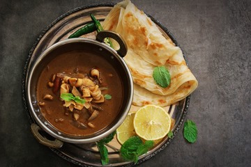 Indian Calamari Squid curry served with Roti or Paratha, overhead view