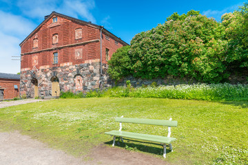 Beautifu city park with bench and ancient house