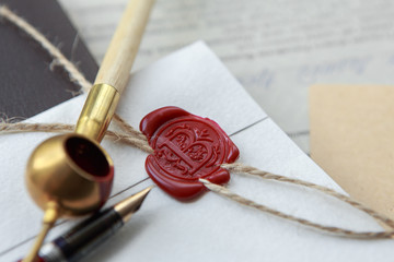 Fountain pen and old notarial wax seal on document, closeup