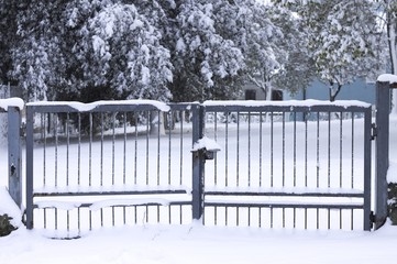 Isolated Iron gate on the snow (Pesaro, Italy)