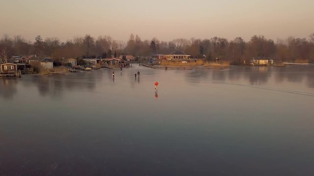 A man is skates on a natural frozen lake in the Netherlands.
