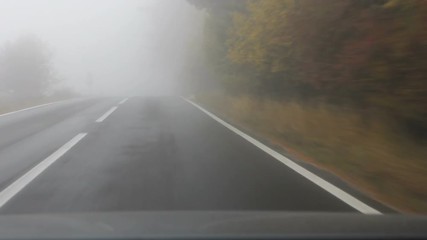 Drive on empty foggy road