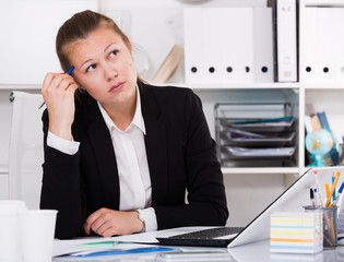 Businesswoman in black suit is having complicated issue with project