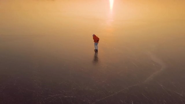 A man is skates on a natural frozen lake in the Netherlands.