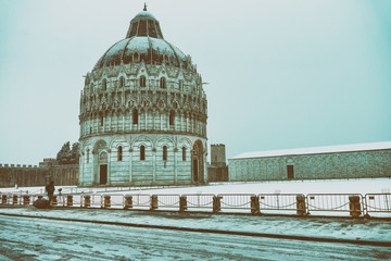 Fototapeta premium Square of Miracles with Baptistery detail at sunrise after a winter snowfall, Pisa - Italy