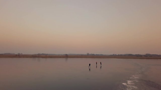 A man is skates on a natural frozen lake in the Netherlands.