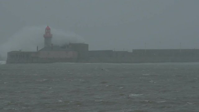 Huge waves crashing on lighthouse in Dun Laoghaire. Emma storm in Dublin, Ireland
