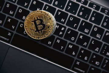 Gold bitcoin on the coins stack, digital money on computer keyboard. Cryptocurrency business concept. Virtual money investment. Cryptocurrency maining.