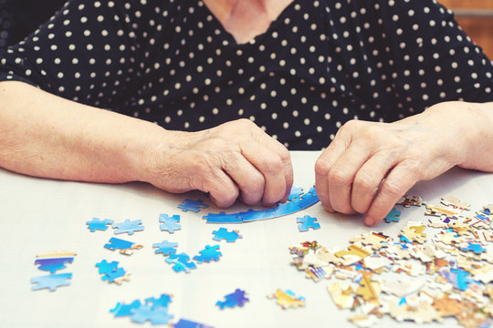 Old Lady Doing A Puzzle