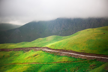 Obraz premium Landscape high mountains in dense fog tops of mountains in clouds North Caucasus Elbrus