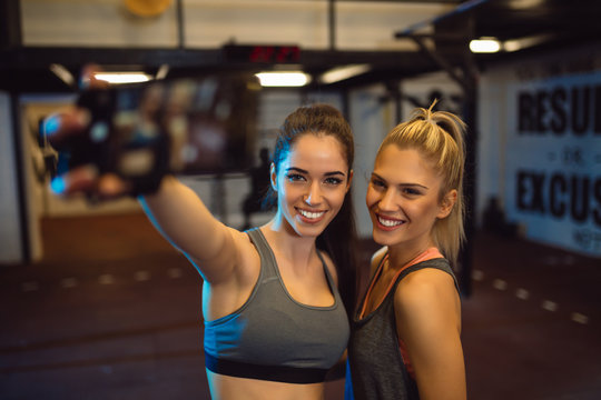 Two beautiful girls in the gym do selfie. Sports, fitness, boxing, gym.