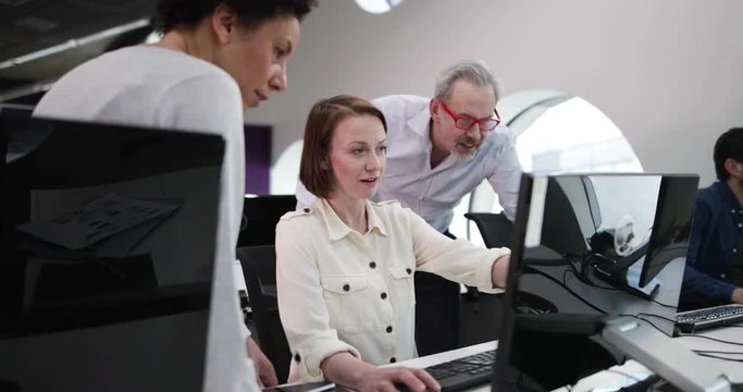 Team looking at computer in an office
