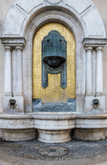 street view of old water fountain in Budapest