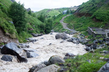 real mountain river rough dirty cold uncontrollable destructive glacier of the glade of Emmanuel...