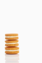 Assorted macaroons over white background with reflection.