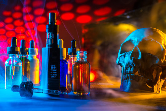 Liquids for electronic cigarettes. Skull with liquids for Vape. Harm to smoking. The harm of electronic cigarettes.