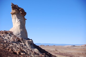 Strange rock formations in badlands with bright blue sky in the Bisti De Na Zin wilderness in Northern New Mexico