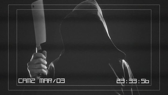 A CCTV camera screen: a faceless friar (a ghost, a ghoul or a madman) throwing an axe chopper in the air. Scary weird horror Halloween clip.

