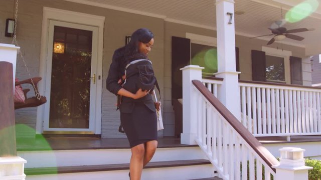 Businesswoman With Baby Son Leaving House For Work
