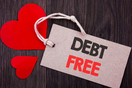 Handwriting Announcement text showing Debt Free. Business concept for Credit Money Financial Sign Freedom From Loan Mortage written on Price tag with Red words on the wooden background.